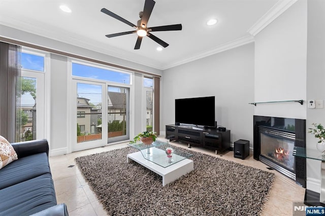52 Myrtle Ave Unit B, Edgewater, NJ 07020 - living room featuring healthy amount of natural light, crown molding, ceiling fan, a glass covered fireplace, and light tile patterned floors