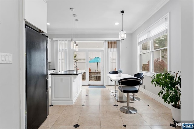 52 Myrtle Ave Unit B, Edgewater, NJ 07020 - kitchen featuring crown molding, white cabinetry, dark countertops, freestanding refrigerator, and decorative light fixtures