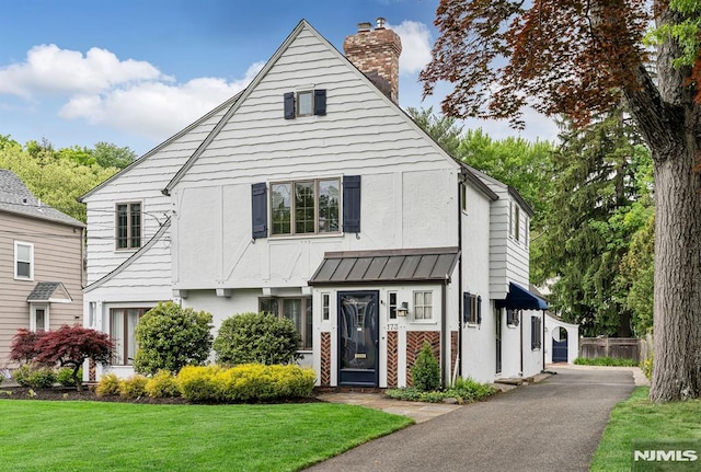 173 Sheridan Ave, Ho-Ho-Kus, NJ 07423 - view of front facade with a chimney and a standing seam roof