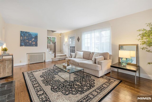173 Sheridan Ave, Ho-Ho-Kus, NJ 07423 - living area featuring radiator heating unit, wood finished floors, stairs, and baseboards