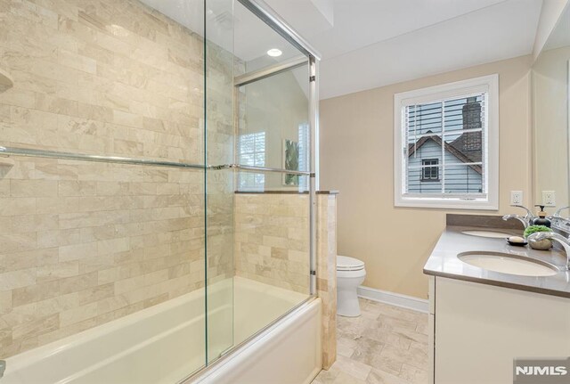 173 Sheridan Ave, Ho-Ho-Kus, NJ 07423 - bathroom with toilet, shower / bath combination with glass door, double vanity, and baseboards