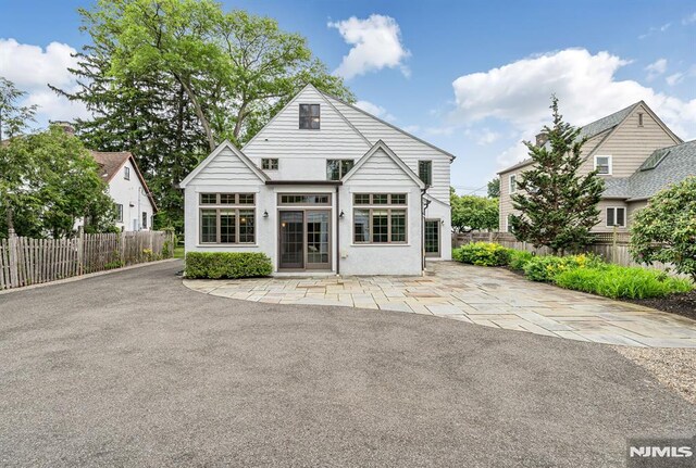 173 Sheridan Ave, Ho-Ho-Kus, NJ 07423 - rear view of house with a patio area and stucco siding