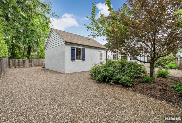 173 Sheridan Ave, Ho-Ho-Kus, NJ 07423 - view of side of home featuring stucco siding and a fenced backyard