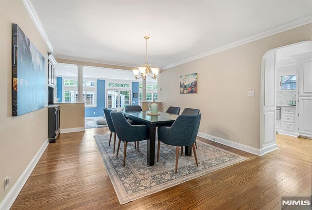 173 Sheridan Ave, Ho-Ho-Kus, NJ 07423 - dining area featuring light wood finished floors, crown molding, baseboards, and a chandelier