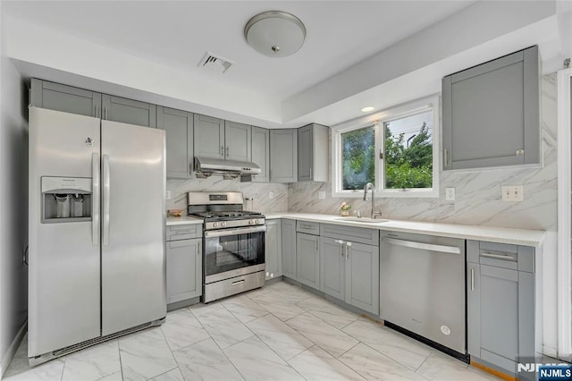2410 3rd St, Fort Lee, NJ 07024 - kitchen featuring stainless steel appliances, gray cabinetry, under cabinet range hood, and a sink