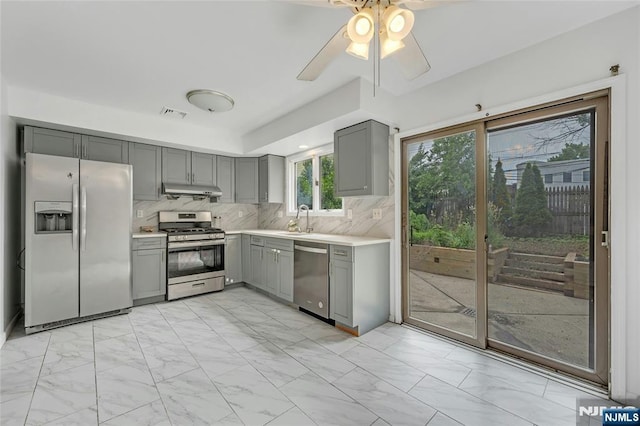 2410 3rd St, Fort Lee, NJ 07024 - kitchen with stainless steel appliances, gray cabinets, a sink, and light marble finish flooring