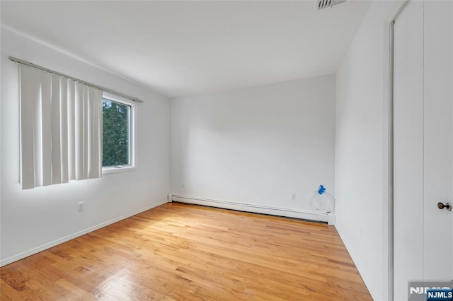 2410 3rd St, Fort Lee, NJ 07024 - unfurnished room featuring baseboard heating, wood finished floors, and baseboards