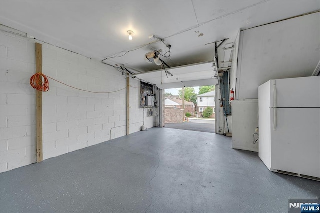 2410 3rd St, Fort Lee, NJ 07024 - garage featuring freestanding refrigerator and concrete block wall