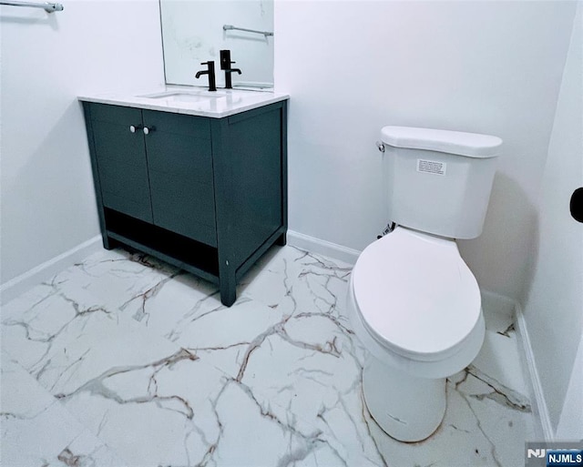 2410 3rd St, Fort Lee, NJ 07024 - bathroom featuring marble finish floors, toilet, vanity, and baseboards