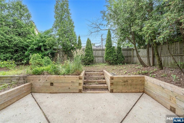 2410 3rd St, Fort Lee, NJ 07024 - fenced backyard featuring a patio and a vegetable garden