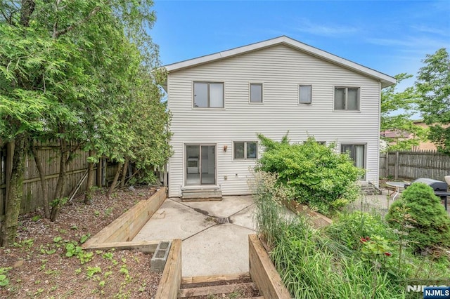 2410 3rd St, Fort Lee, NJ 07024 - rear view of house with a fenced backyard and a patio area
