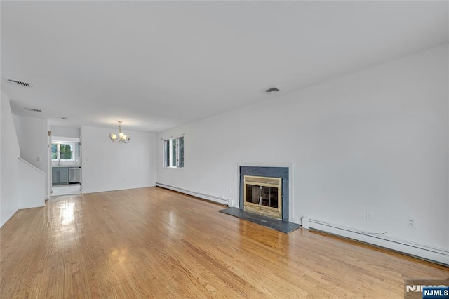 2410 3rd St, Fort Lee, NJ 07024 - unfurnished living room with a baseboard heating unit, a chandelier, and light wood finished floors