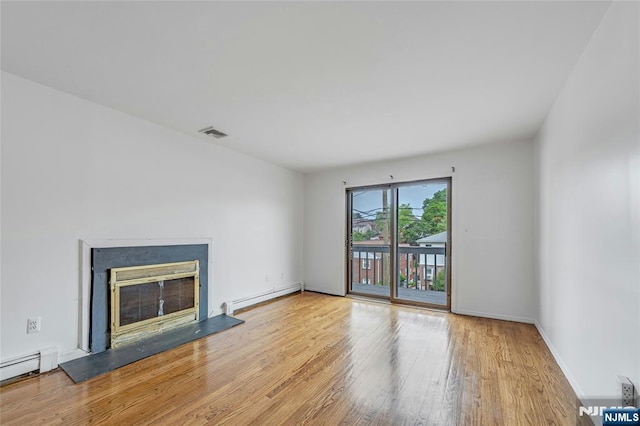 2410 3rd St, Fort Lee, NJ 07024 - unfurnished living room featuring baseboard heating, wood finished floors, a glass covered fireplace, and baseboards