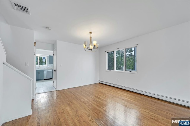 2410 3rd St, Fort Lee, NJ 07024 - empty room with a baseboard radiator, a chandelier, plenty of natural light, and light wood-style flooring