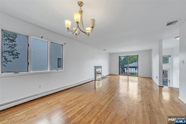 2410 3rd St, Fort Lee, NJ 07024 - unfurnished living room with a chandelier, wood finished floors, baseboard heating, and a fireplace with flush hearth