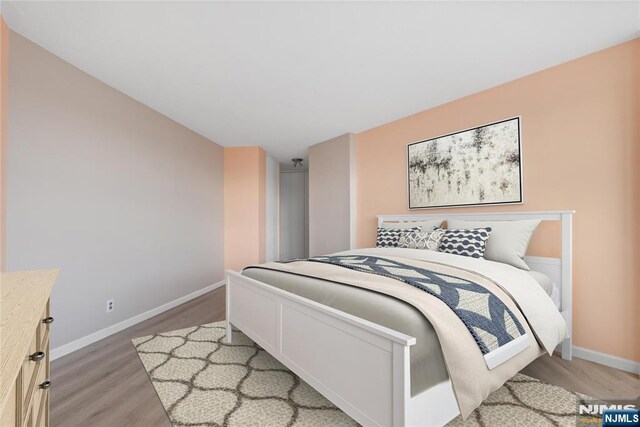 7004 E Kennedy Blvd Unit 28C, Guttenberg, NJ 07093 - bedroom with light wood-type flooring and baseboards