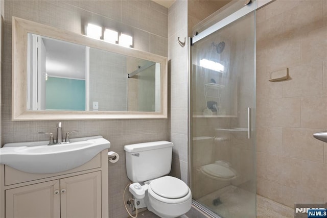 7004 E Kennedy Blvd Unit 28C, Guttenberg, NJ 07093 - full bath featuring toilet, a shower stall, vanity, and tile walls