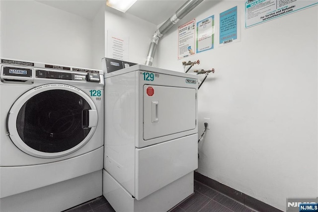 7004 E Kennedy Blvd Unit 28C, Guttenberg, NJ 07093 - community laundry with washer and dryer and dark tile patterned flooring