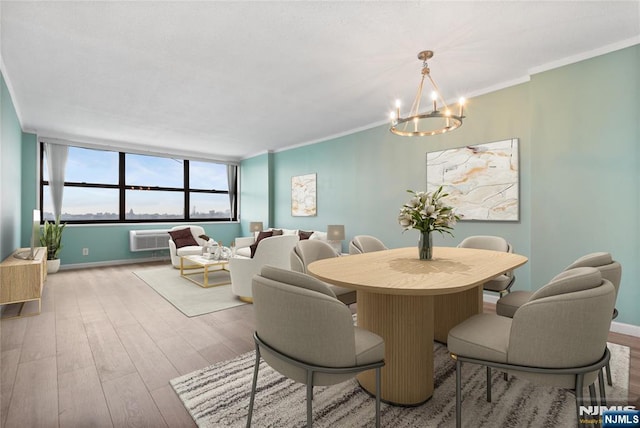 7004 E Kennedy Blvd Unit 28C, Guttenberg, NJ 07093 - dining area featuring a chandelier, wood finished floors, crown molding, baseboards, and a wall mounted air conditioner
