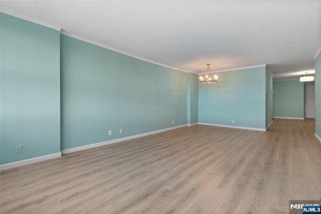 7004 E Kennedy Blvd Unit 28C, Guttenberg, NJ 07093 - empty room with a chandelier, ornamental molding, light wood-type flooring, and baseboards