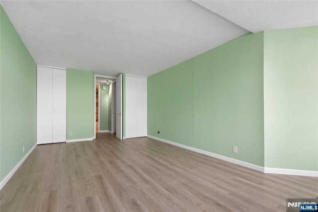 7004 E Kennedy Blvd Unit 28C, Guttenberg, NJ 07093 - unfurnished living room with light wood-style floors and baseboards