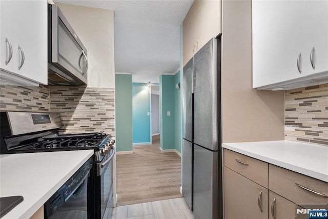 7004 E Kennedy Blvd Unit 28C, Guttenberg, NJ 07093 - kitchen featuring appliances with stainless steel finishes, light countertops, decorative backsplash, and baseboards