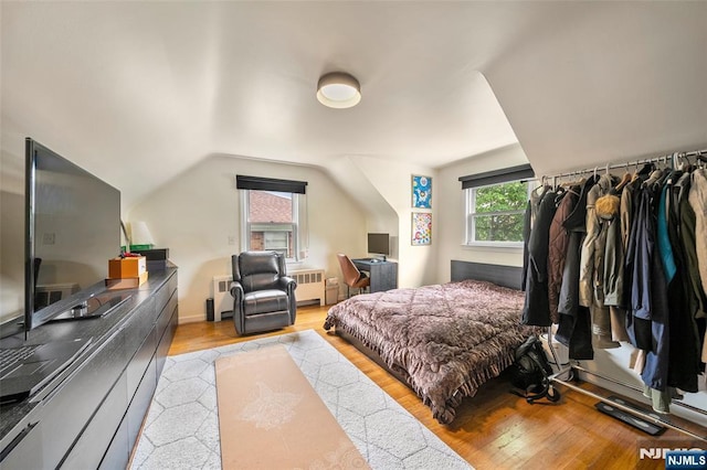 344 Northwood Way, Palisades Park, NJ 07650 - bedroom featuring radiator, light wood-style floors, an office area, and lofted ceiling