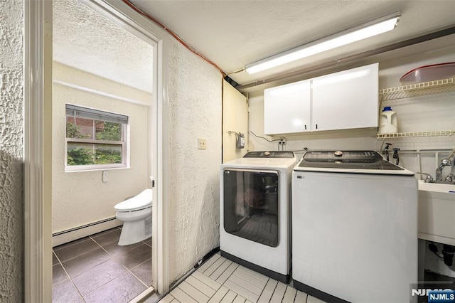 344 Northwood Way, Palisades Park, NJ 07650 - laundry room featuring a baseboard heating unit, cabinet space, a textured wall, washer and clothes dryer, and light tile patterned floors