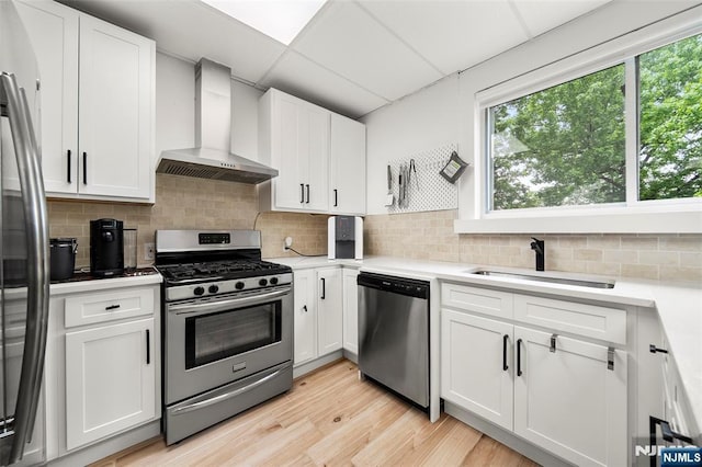 344 Northwood Way, Palisades Park, NJ 07650 - kitchen with appliances with stainless steel finishes, wall chimney range hood, a sink, and white cabinetry