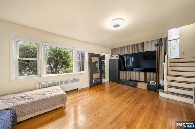 344 Northwood Way, Palisades Park, NJ 07650 - bedroom featuring radiator heating unit, wood-type flooring, and an accent wall