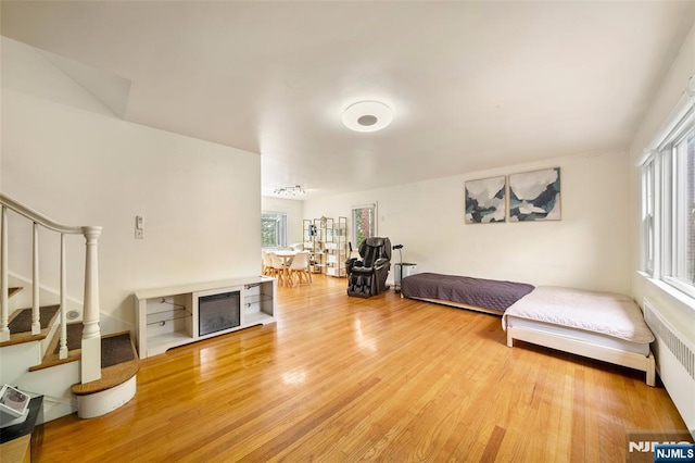 344 Northwood Way, Palisades Park, NJ 07650 - living area featuring light wood-type flooring, stairway, and radiator heating unit