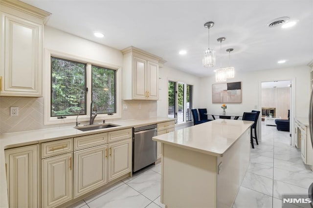 45 Longridge Rd, Montvale, NJ 07645 - kitchen with cream cabinets, stainless steel dishwasher, a sink, light marble finish flooring, and a kitchen island