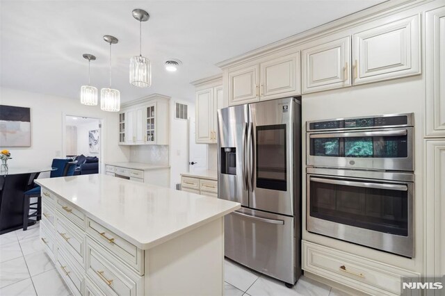 45 Longridge Rd, Montvale, NJ 07645 - kitchen featuring stainless steel appliances, glass insert cabinets, light countertops, and a center island