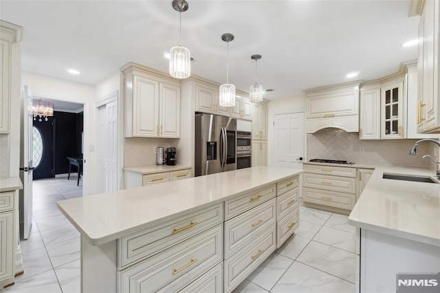 45 Longridge Rd, Montvale, NJ 07645 - kitchen featuring stainless steel appliances, a sink, light marble finish floors, a kitchen island, and tasteful backsplash