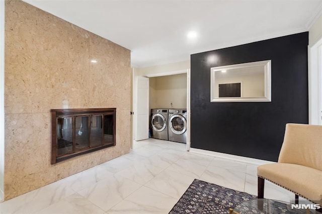 45 Longridge Rd, Montvale, NJ 07645 - living room featuring washing machine and clothes dryer, a glass covered fireplace, marble look tile flooring, and ornamental molding
