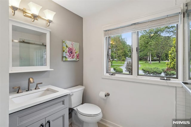 45 Longridge Rd, Montvale, NJ 07645 - bathroom featuring vanity, toilet, tiled shower, and baseboards