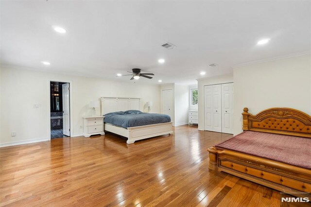 45 Longridge Rd, Montvale, NJ 07645 - bedroom with two closets, light wood-style flooring, recessed lighting, baseboards, and crown molding