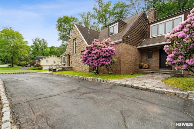 45 Longridge Rd, Montvale, NJ 07645 - view of property exterior with a shingled roof, a chimney, and brick siding