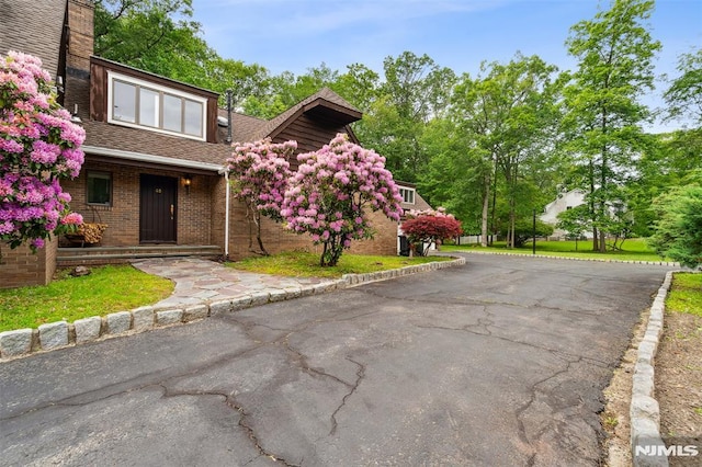 45 Longridge Rd, Montvale, NJ 07645 - view of front of property featuring brick siding, a shingled roof, and a porch