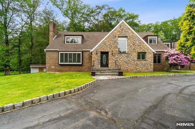 45 Longridge Rd, Montvale, NJ 07645 - view of front of home with a chimney, roof with shingles, stone siding, and a front lawn