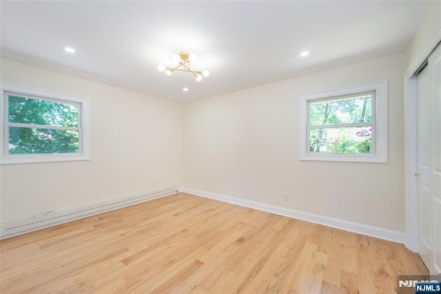 112 Fern St, Twp Of Washington, NJ 07676 - unfurnished room with light wood-style flooring, baseboards, recessed lighting, a baseboard radiator, and a chandelier