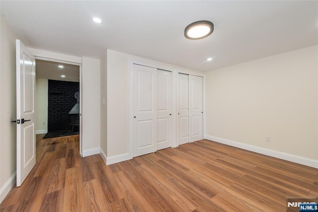 112 Fern St, Twp Of Washington, NJ 07676 - unfurnished bedroom featuring multiple closets, wood finished floors, baseboards, and recessed lighting