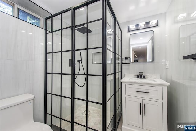 112 Fern St, Twp Of Washington, NJ 07676 - bathroom with tiled shower, vanity, toilet, and tile walls
