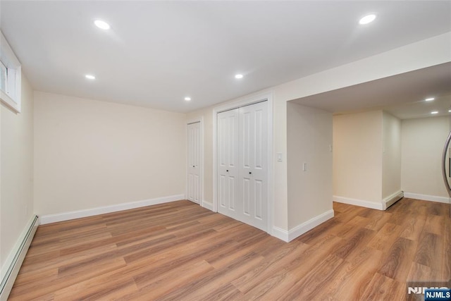 112 Fern St, Twp Of Washington, NJ 07676 - below grade area featuring a baseboard radiator, light wood-style floors, baseboards, and recessed lighting