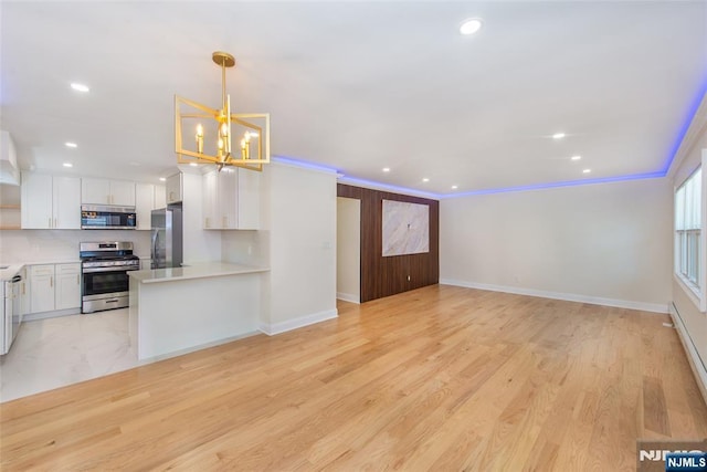 112 Fern St, Twp Of Washington, NJ 07676 - kitchen featuring appliances with stainless steel finishes, white cabinets, light countertops, open floor plan, and recessed lighting