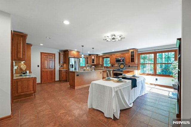 68 Birch St, Ramsey, NJ 07446 - kitchen featuring stainless steel appliances, a kitchen island, brown cabinets, recessed lighting, and glass insert cabinets