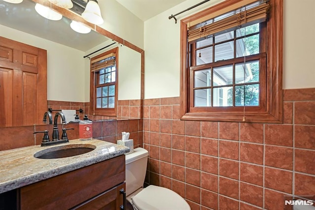 68 Birch St, Ramsey, NJ 07446 - half bathroom featuring tile walls, toilet, vanity, and a wainscoted wall