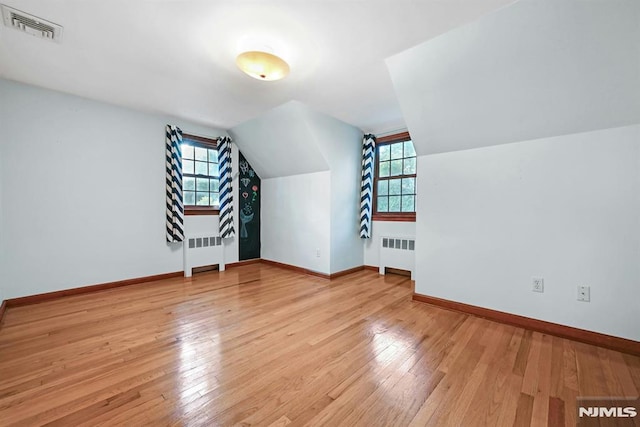 68 Birch St, Ramsey, NJ 07446 - bonus room with radiator, plenty of natural light, hardwood / wood-style floors, and vaulted ceiling
