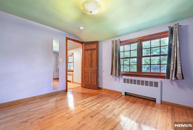 68 Birch St, Ramsey, NJ 07446 - spare room with radiator heating unit, baseboards, wood finished floors, and lofted ceiling