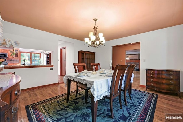68 Birch St, Ramsey, NJ 07446 - dining space featuring a chandelier, light wood finished floors, and baseboards